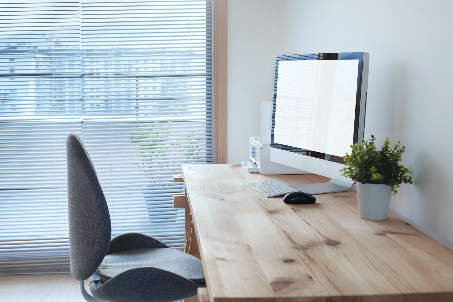workspace interior with computer on wooden table and office chair